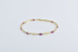 10K Oval Natural Ruby Diamond Accent Twist Link Bracelet 7" Yellow Gold