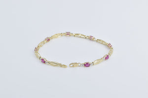 10K Oval Natural Ruby Diamond Accent Twist Link Bracelet 7" Yellow Gold