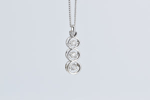 10K Tiered Dancing Diamond Three Stone Twist Pendant White Gold