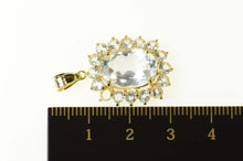Load image into Gallery viewer, 14K Oval Syn. Blue Topaz Halo Statement Pendant Yellow Gold