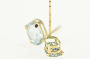 10K Oval Syn. Aquamarine Solitaire Stud Earrings Yellow Gold