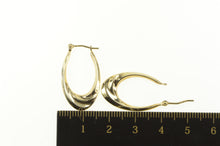 Load image into Gallery viewer, 10K 25.7mm Puffy Oval Swirl Curvy Fashion Hoop Earrings Yellow Gold