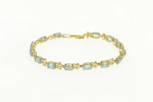 Load image into Gallery viewer, 14K Oval Blue Topaz Diamond Flower Tennis Bracelet 7&quot; Yellow Gold