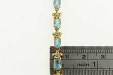 Load image into Gallery viewer, 14K Oval Blue Topaz Diamond Flower Tennis Bracelet 7&quot; Yellow Gold